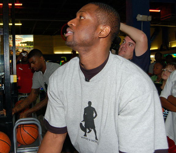 Miami Heat guard Dwyane Wade working on his Pop-A-Shot skills at his Foundation's annual charity Christmas Party at Boomer's in Dania Beach, Fla.