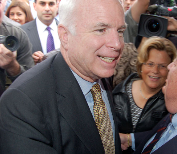 Arizona Senator John McCain navigates his way through an overflow crowd of supporters at Café Versailles in Little Havana.