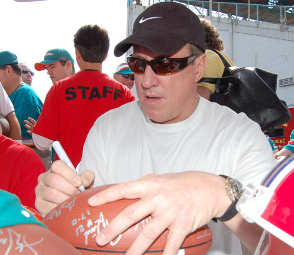 Ex-University of Miami and Buffalo Bills quarterback Jim Kelly signs autographs for fans at the Orange Bowl closing ceremonies.