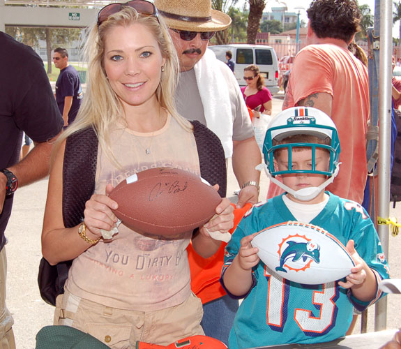 Fans show off some of their newly autographed paraphernalia during the Orange Bowl closing ceremonies.