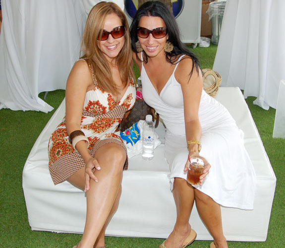 Guests try to cool down in the sweltering heat at the Miami Beach Golf Club during DJ Irie's Celebrity Golf Event in Miami Beach, Fla.