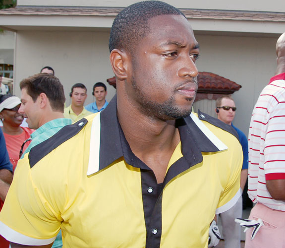 Miami Heat shooting guard Dwyane Wade readies to hit the links at the Blue Monster for the Zo's Summer Groove celebrity golf event in Doral, Fla.
