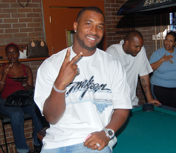 Miami Dolphins quarterback Daunte Culpepper relaxes before the start of bowling at teammate Randy McMichael's charity bowling event in Pembroke Pines, Fla.
